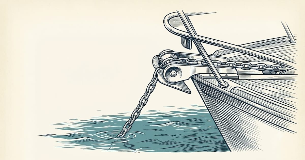 Anchor chain running over a bow roller into the water